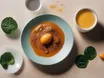 Iron-rich foods, eggs, spinach, B12 and CoQ10 capsules and a cup of coffee on a bright surface